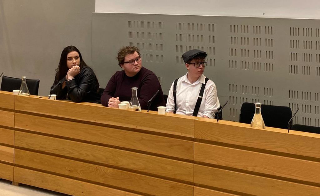 Three young people at a panel