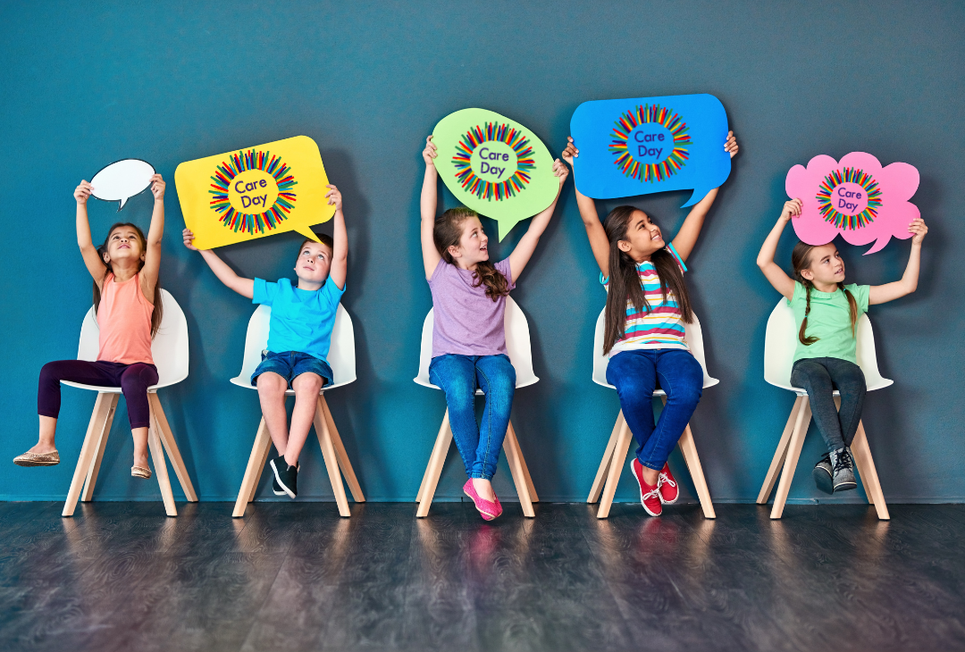Group of children holding up speech bubble signs