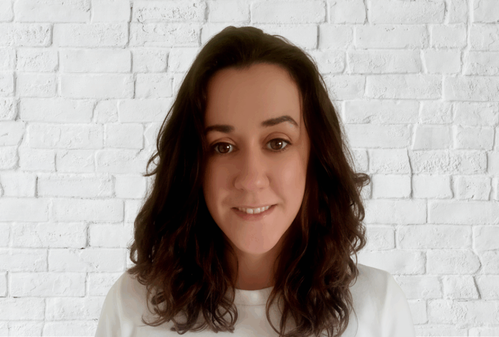 Headshot of Hazel Comerford, EPIC's SEA Advocacy Officer. She has medium length curly brown hair. She is wearing a white t-shirt.