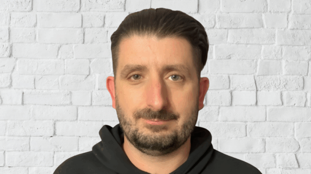Headshot of Stephen Maguire, an SEA Advocate Officer at EPIC. He has short dark brown hair, he has a beard and mustache, and is wearing a dark hoodie.