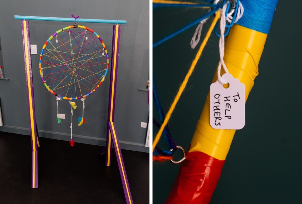 Colourful string-art display with a tag reading “To Help Others”.