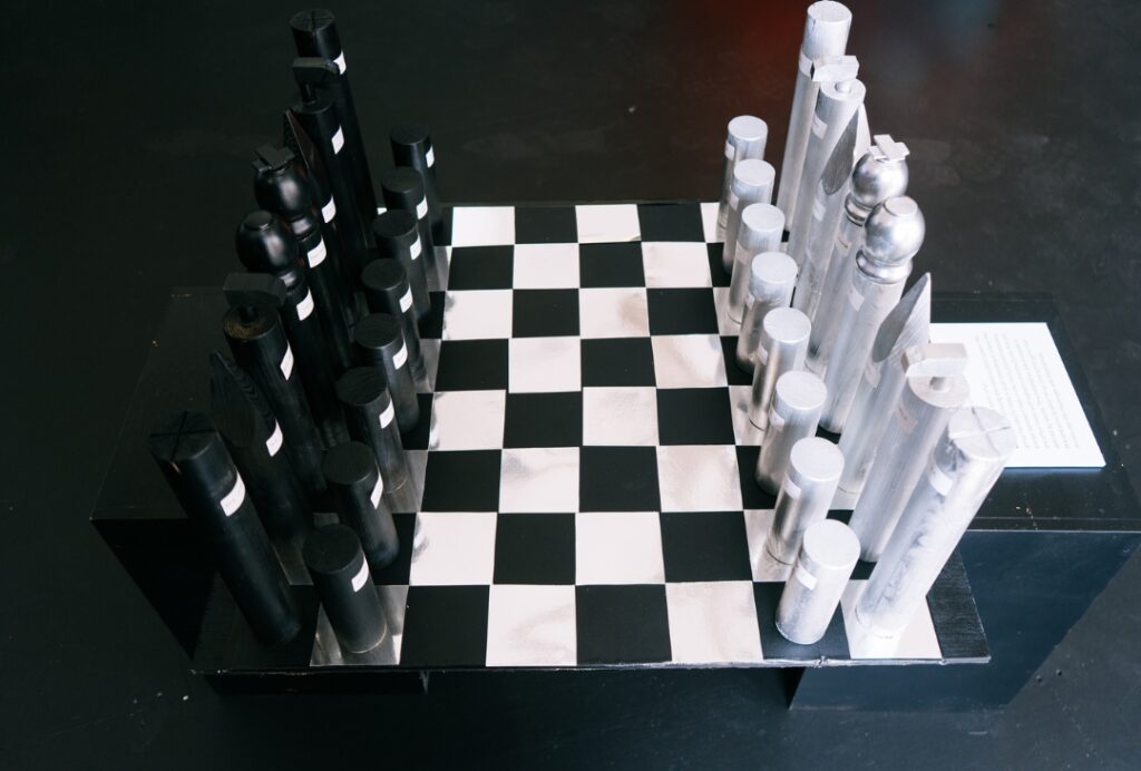Black and silver chess set with labels on each chess piece.