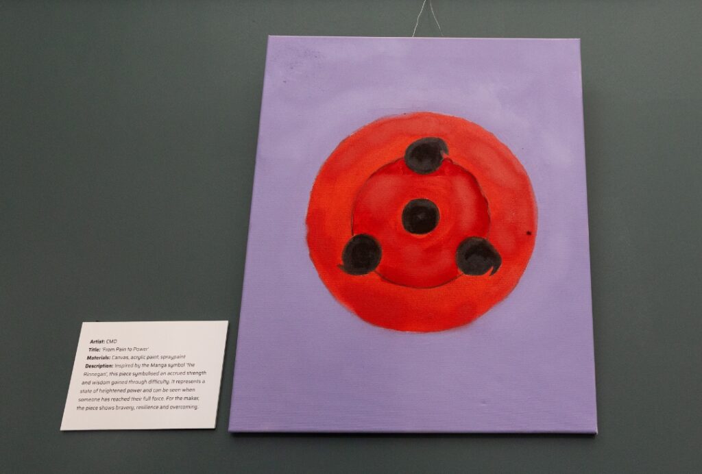 Purple canvas featuring a large red circular symbol with black markings