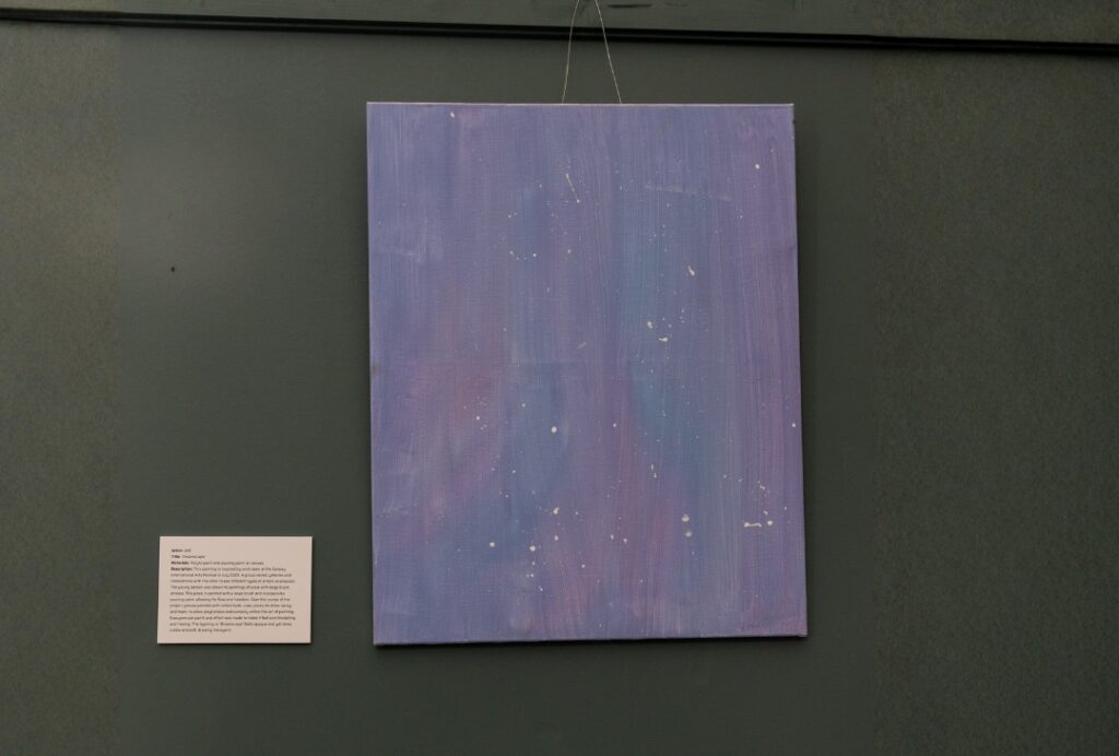 Soft blue abstract painting with layered tones and scattered white speckles resembling stars or paint splashes.
